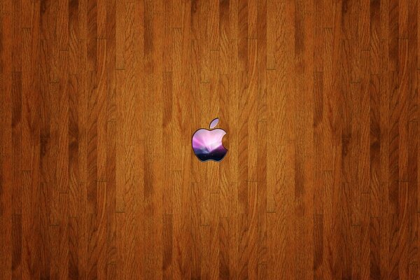 Piccola icona Apple colorata su sfondo in legno